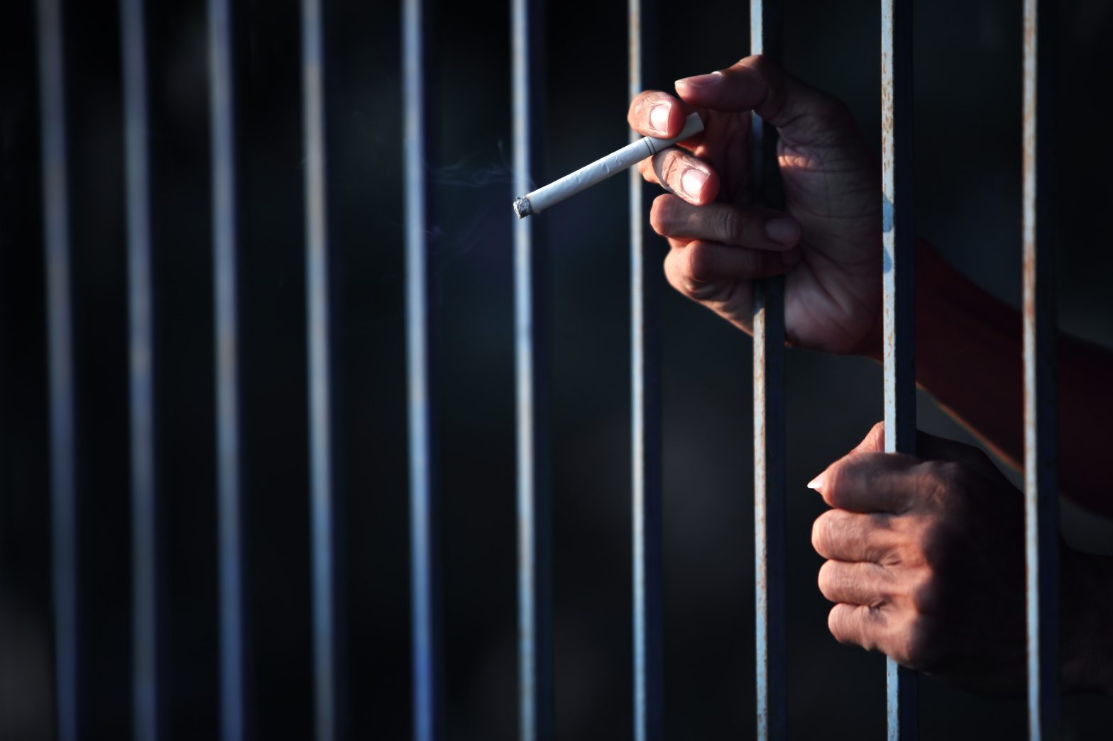 Prisoner behind bars with a cigarettes. Shauna Boatright - bribery in prison