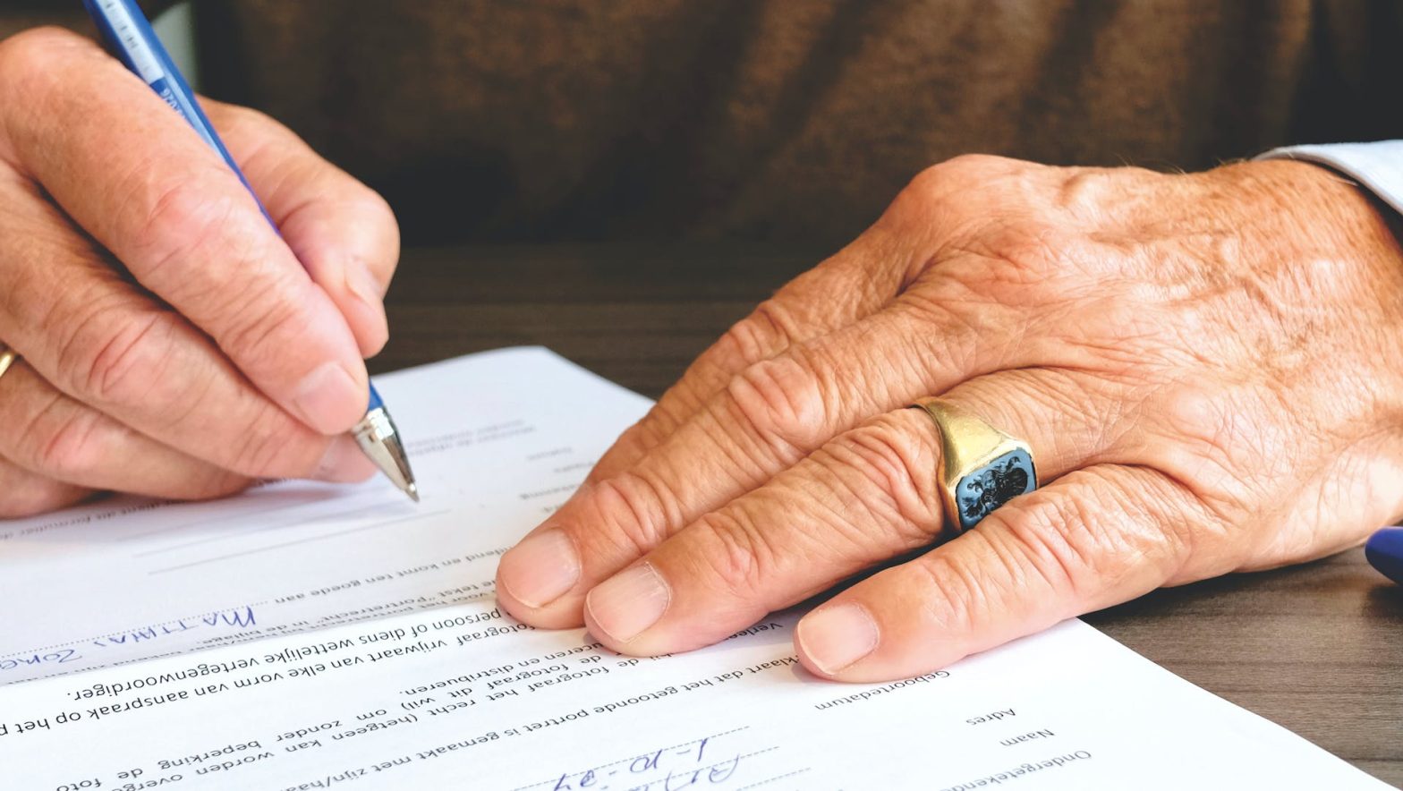 A person signing documents. Standards greenlight - jails in Colorado.