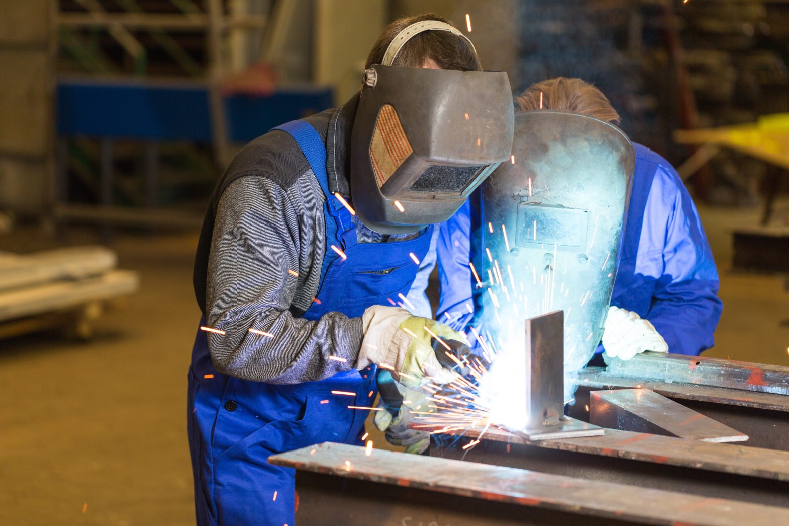 An image of a man training a student to weld. inmate education - Milwaukee County