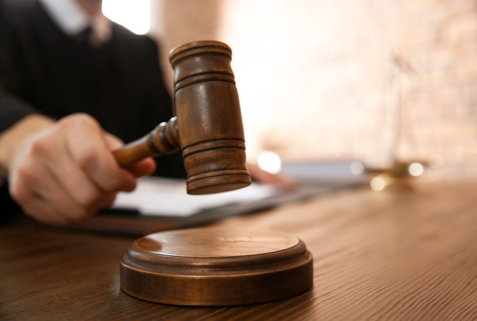 A gavel at table in courtroom, closeup. Werner Gramajo - Northern State Prison