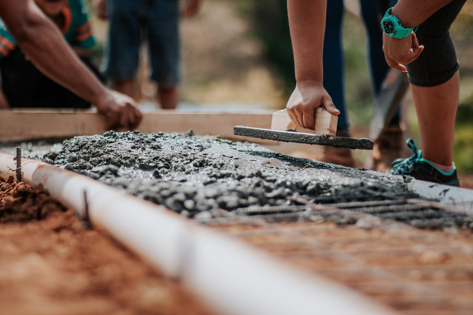 Construction workers laying cement. News - Arapahoe County jail expansion