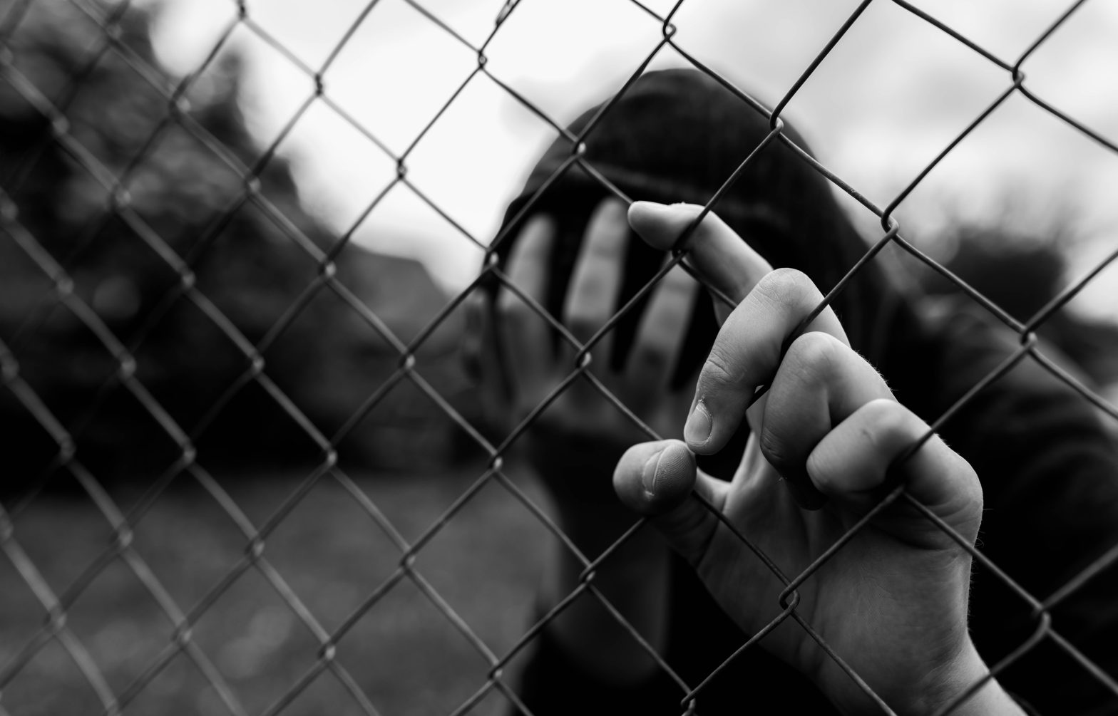 Young unidentifiable teenager holding the wired fence. News - Campbell Regional Juvenile Detention Center, Michelle Ratliff, Betty Tucker