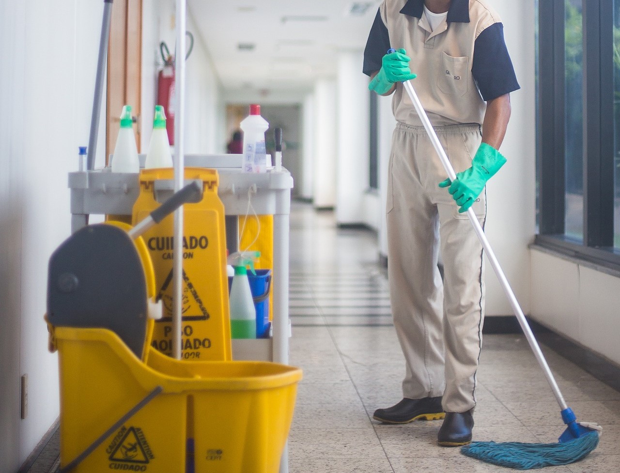 A man mopping a corridor. News - Northwest Detention Center in Tacoma faces $23 million penalty for wage violations