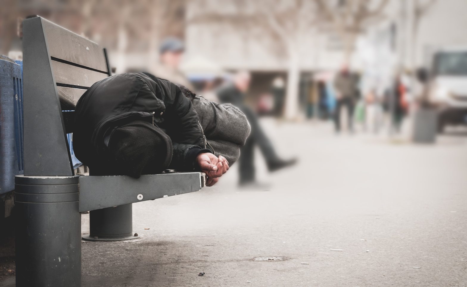 A homeless man is sleeping on a bench. News - Danville Residents Advocate Against Jail as a Homeless Shelter in Boyle County