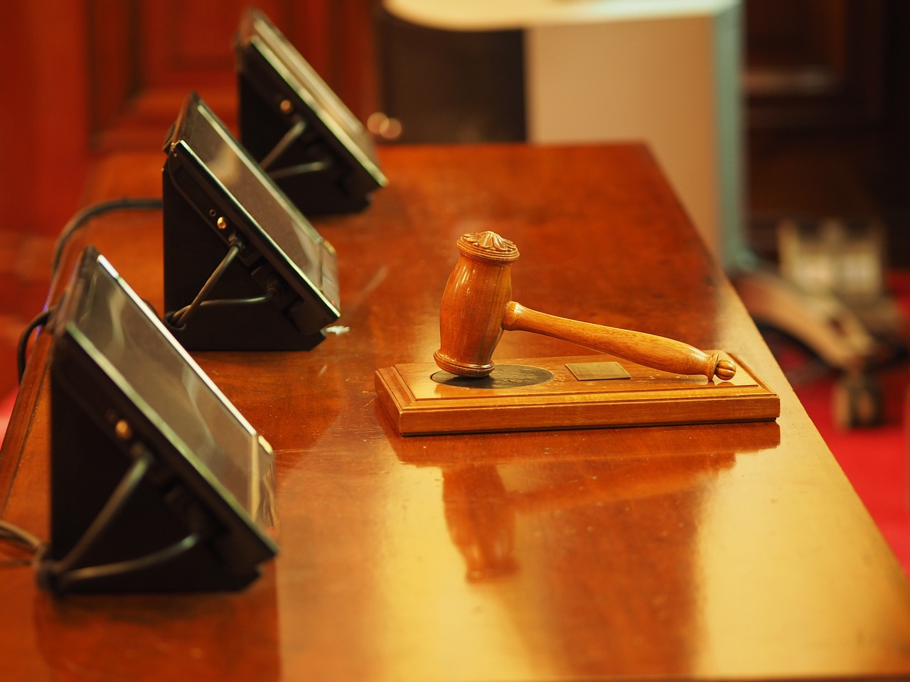 A gavel and audio monitors on a table. News - The Allen County Jail lease objection hearing set today; can be viewed online