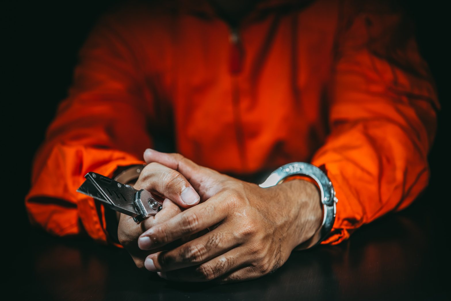 A handcuffed prisoner is holding a knife. News - Yasmin Talbot and inmate Christopher Wright charged with promoting prison contraband and conspiracy